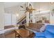 Spacious living room with high ceilings, a ceiling fan, comfortable couches, and a staircase at 3626 Lake Joyce Dr, Land O Lakes, FL 34639