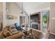 Comfortable living room featuring a fireplace, hardwood floors, many windows and vaulted ceilings at 3626 Lake Joyce Dr, Land O Lakes, FL 34639