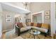 Living room with large sectional sofa, an archway into the kitchen, and bright natural light at 3626 Lake Joyce Dr, Land O Lakes, FL 34639