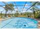 Spacious screened-in pool with sparkling water and a surrounding deck, offering a refreshing oasis for outdoor enjoyment at 3626 Lake Joyce Dr, Land O Lakes, FL 34639