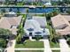 Aerial view of house with pool, canal access, mature trees, and well-manicured landscaping at 4604 Blue Marlin Dr, Bradenton, FL 34208