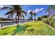 Landscaped backyard with canal, lush green grass, and access to the waterway at 4604 Blue Marlin Dr, Bradenton, FL 34208