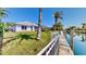 Beautiful canal home with grassy lawn, private dock, and tranquil waterfront setting at 4604 Blue Marlin Dr, Bradenton, FL 34208