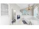 Bright bathroom featuring a soaking tub, chandelier, and large window offering plenty of natural light at 4604 Blue Marlin Dr, Bradenton, FL 34208