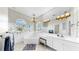 Elegant bathroom with a soaking tub, dual sinks, vanity area, and a large mirror at 4604 Blue Marlin Dr, Bradenton, FL 34208