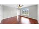 This spacious bedroom has hardwood floors, a ceiling fan, and a large window with lots of natural light at 4604 Blue Marlin Dr, Bradenton, FL 34208