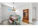 Charming dining area with rustic wooden furniture and a decorative hall tree storage rack at 4604 Blue Marlin Dr, Bradenton, FL 34208