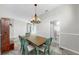 Cozy dining room featuring modern lighting and adjacent rooms with tiled flooring and neutral walls at 4604 Blue Marlin Dr, Bradenton, FL 34208
