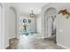 Bright foyer with arched doorways, a decorative light fixture, and double doors leading to the exterior at 4604 Blue Marlin Dr, Bradenton, FL 34208