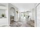 Open foyer showcasing tile flooring, arched doorways, access to a bedroom, and views of the pool area at 4604 Blue Marlin Dr, Bradenton, FL 34208