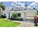 Charming home with well-kept lawn, white siding, and manicured landscaping at 4604 Blue Marlin Dr, Bradenton, FL 34208