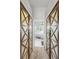 Hallway featuring custom barn doors and an ensuite bathroom at 4604 Blue Marlin Dr, Bradenton, FL 34208