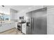 Updated kitchen features white cabinets, stainless steel appliances, and a view of the living area at 4604 Blue Marlin Dr, Bradenton, FL 34208
