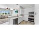Modern kitchen featuring white cabinetry, stainless appliances, and an open connection to the living space at 4604 Blue Marlin Dr, Bradenton, FL 34208
