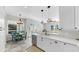 Bright open kitchen with white cabinetry, stainless steel appliances and an adjacent eat-in area at 4604 Blue Marlin Dr, Bradenton, FL 34208