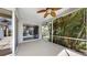 This cozy screened in lanai has a ceiling fan and overlooks lush tropical landscaping at 4604 Blue Marlin Dr, Bradenton, FL 34208
