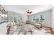 Bright living room featuring stylish decor, a ceiling fan, and sliding doors overlooking the pool at 4604 Blue Marlin Dr, Bradenton, FL 34208