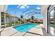 Inviting screened-in pool and spa area surrounded by lush landscaping at 4604 Blue Marlin Dr, Bradenton, FL 34208