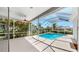 This covered and screened in lanai offers a view of the pool and lush landscaping at 4604 Blue Marlin Dr, Bradenton, FL 34208