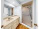 Bathroom vanity with beige counter tops and a frosted glass door shower at 4851 Leyte Ct, New Port Richey, FL 34655