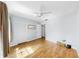 Bedroom with wood-look floors, a ceiling fan, and double door closet at 4851 Leyte Ct, New Port Richey, FL 34655