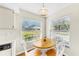 Bright breakfast nook features a wood table, white chairs, and sun-drenched windows at 4851 Leyte Ct, New Port Richey, FL 34655