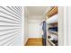 Walk-in closet with wood-look flooring, built-in shelving, and ample storage space at 4851 Leyte Ct, New Port Richey, FL 34655