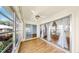Bright Florida room boasts many windows and sliding glass doors with wood-look floors at 4851 Leyte Ct, New Port Richey, FL 34655