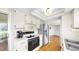 Kitchen with stainless steel appliances, wood floors, and bright white cabinets at 4851 Leyte Ct, New Port Richey, FL 34655