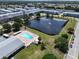 A beautiful aerial view of a complex with a swimming pool and a pond with a fountain at 5810 21St N St # 10, St Petersburg, FL 33714