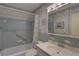 A charming bathroom with blue tile, tub, and decorative accents at 5810 21St N St # 10, St Petersburg, FL 33714