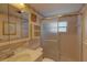 A pink-themed bathroom featuring a glass shower enclosure and decorative wallpaper at 5810 21St N St # 10, St Petersburg, FL 33714