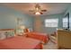 Bright bedroom featuring two twin beds, ceiling fan, and window with blinds at 5810 21St N St # 10, St Petersburg, FL 33714