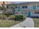 Charming condo with well-maintained landscaping, teal doors and stairs at 5810 21St N St # 10, St Petersburg, FL 33714