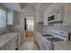 Functional kitchen with white appliances, bright lighting and sunroom access at 5810 21St N St # 10, St Petersburg, FL 33714