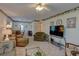 Cozy living room with comfortable furnishings, a ceiling fan, and lots of natural light at 5810 21St N St # 10, St Petersburg, FL 33714
