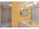 Bright bathroom with yellow walls, single sink vanity, and tub with tile surround at 5940 Pelican Bay S Plz # 504, Gulfport, FL 33707