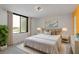 This bedroom is staged with an area rug and king bed at 5940 Pelican Bay S Plz # 504, Gulfport, FL 33707