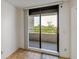 Bedroom featuring sliding glass door out to balcony, tile flooring, and natural light at 5940 Pelican Bay S Plz # 504, Gulfport, FL 33707