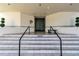 Elegant condominium building entrance featuring stairs and prominent double doors at 5940 Pelican Bay S Plz # 504, Gulfport, FL 33707
