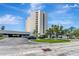 Exterior view of a tall building with a parking lot and well-maintained grounds at 5940 Pelican Bay S Plz # 504, Gulfport, FL 33707