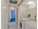 Tiled laundry room area with a washer and dryer combo at 5940 Pelican Bay S Plz # 504, Gulfport, FL 33707