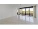An empty living room with a large balcony at 5940 Pelican Bay S Plz # 504, Gulfport, FL 33707
