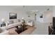 A living room with a mirror wall, a coffee table, a sofa, and chairs at 5940 Pelican Bay S Plz # 504, Gulfport, FL 33707