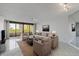 A beautifully staged living room with a view of the balcony at 5940 Pelican Bay S Plz # 504, Gulfport, FL 33707