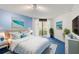 Bright main bedroom with serene beach themed decor and balcony access at 5940 Pelican Bay S Plz # 504, Gulfport, FL 33707