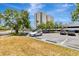 Exterior shot of a parking lot with trees and grass, featuring a white car at 5940 Pelican Bay S Plz # 504, Gulfport, FL 33707
