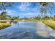 Beautiful water view of a serene pond with a fountain in a lush, green community at 5940 Pelican Bay S Plz # 504, Gulfport, FL 33707