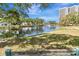 Scenic pond with a fountain and mature trees in a landscaped community setting at 5940 Pelican Bay S Plz # 504, Gulfport, FL 33707