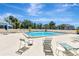 Community pool and patio with several chairs and seating at 5940 Pelican Bay S Plz # 504, Gulfport, FL 33707